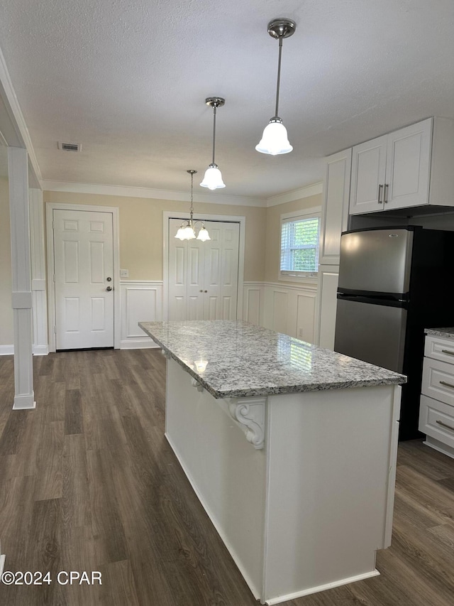 2849 Miltonia Ave, Marianna, FL 32448 - kitchen featuring freestanding refrigerator, dark wood-type flooring, a center island, white cabinetry, and ornamental molding