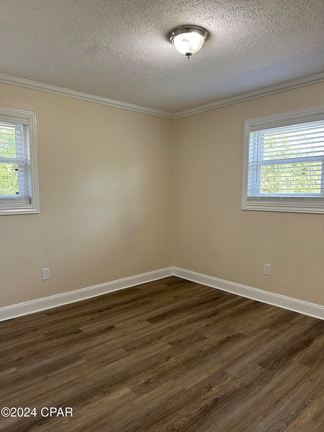 unfurnished room featuring a textured ceiling, a wealth of natural light, crown molding, and dark hardwood / wood-style floors