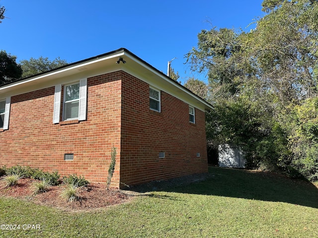 view of side of home with a lawn