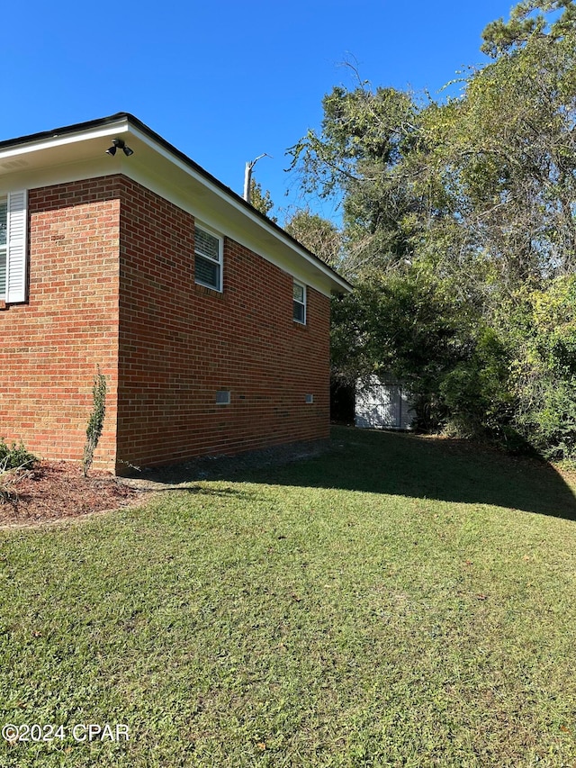 view of side of property with a yard