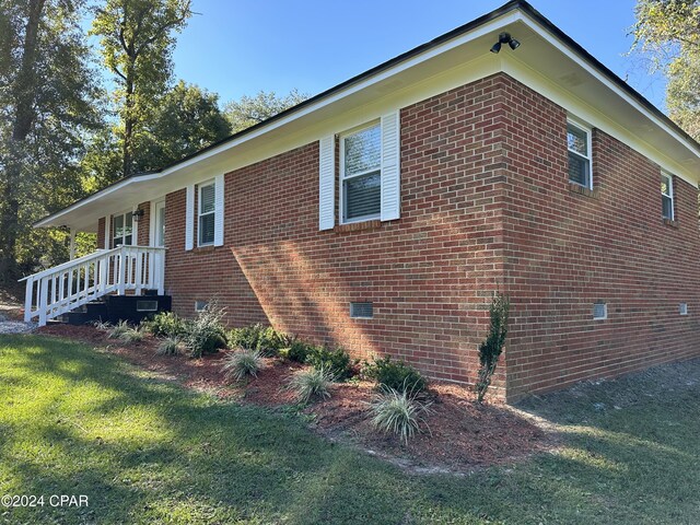 2849 Miltonia Ave, Marianna, FL 32448 - view of property exterior featuring a lawn, brick siding, and crawl space