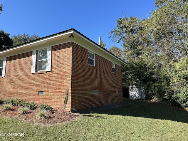 2849 Miltonia Ave, Marianna, FL 32448 - view of side of property featuring a lawn, brick siding, and crawl space