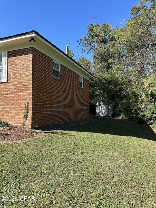 2849 Miltonia Ave, Marianna, FL 32448 - view of home's exterior featuring a yard and brick siding