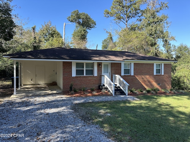 2849 Miltonia Ave, Marianna, FL 32448 - ranch-style house featuring driveway, a front lawn, brick siding, and a carport