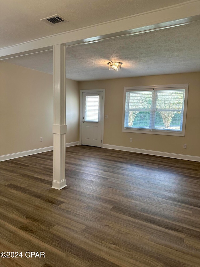 interior space featuring dark hardwood / wood-style flooring and a textured ceiling