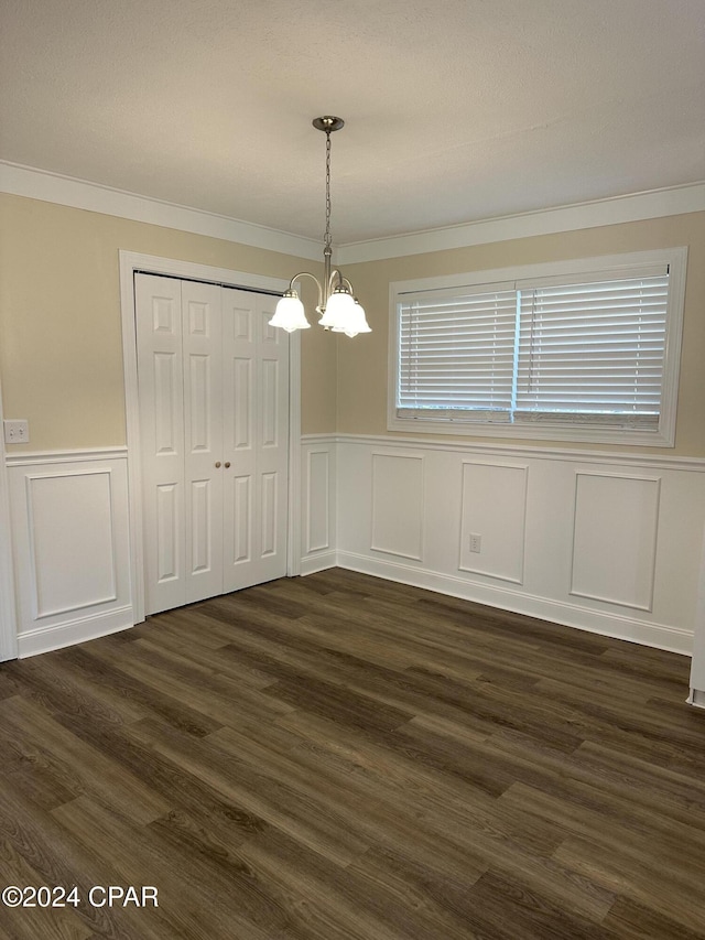 2849 Miltonia Ave, Marianna, FL 32448 - unfurnished dining area featuring a decorative wall, ornamental molding, a chandelier, wainscoting, and dark wood finished floors