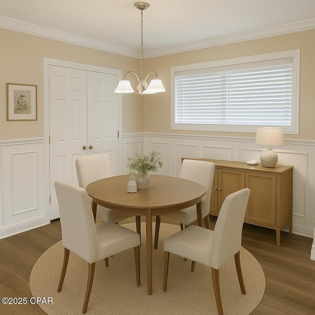 2849 Miltonia Ave, Marianna, FL 32448 - dining room with a decorative wall, a chandelier, dark wood-type flooring, ornamental molding, and a wainscoted wall