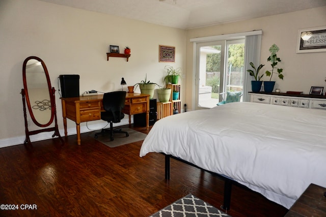 bedroom featuring access to exterior and dark hardwood / wood-style flooring