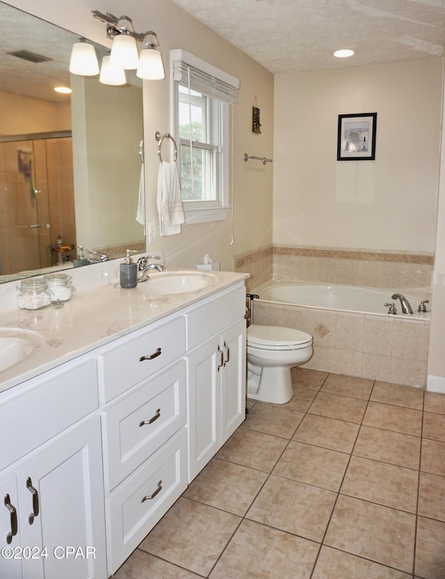 full bathroom with tile patterned flooring, a textured ceiling, vanity, toilet, and separate shower and tub