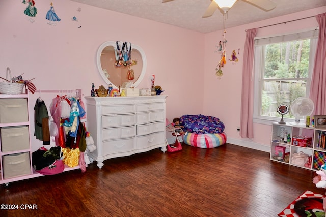 playroom with ceiling fan, wood-type flooring, and a textured ceiling