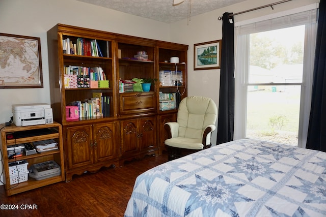 bedroom with dark wood-type flooring and a textured ceiling