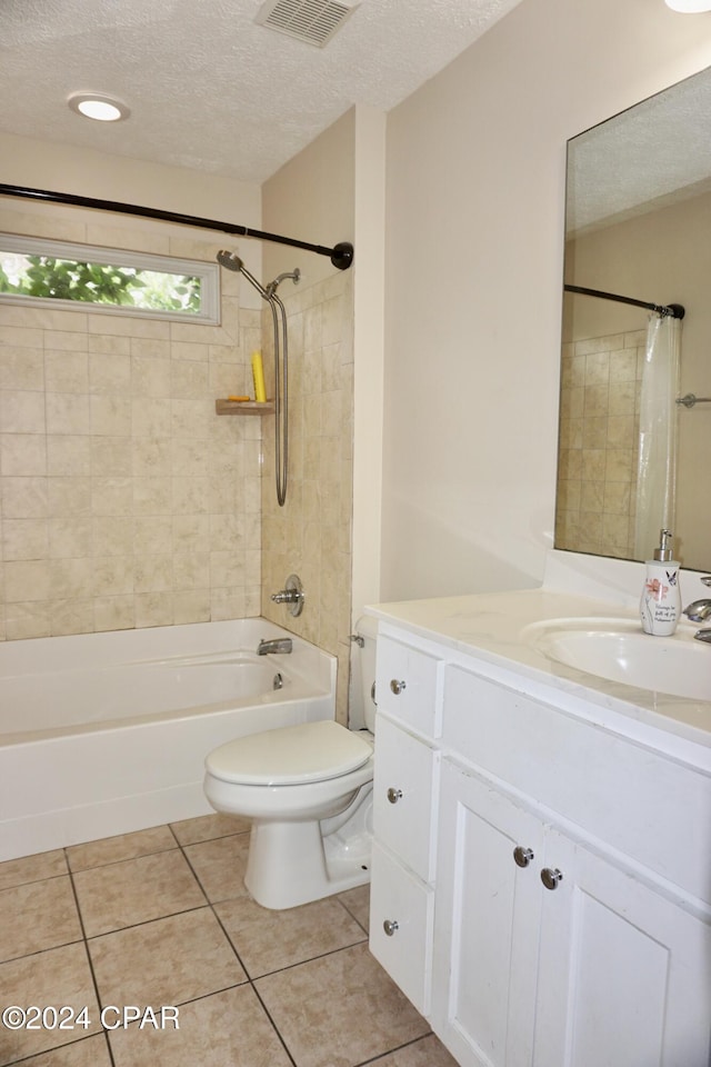 full bathroom featuring vanity, a textured ceiling, and tile patterned flooring