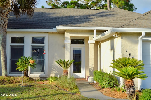 view of exterior entry featuring a garage