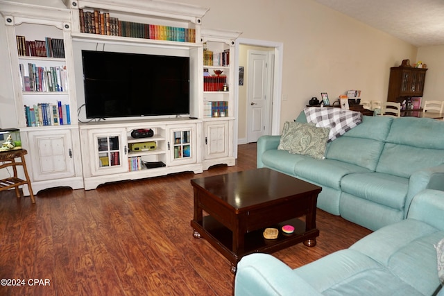 living room featuring dark hardwood / wood-style floors and vaulted ceiling