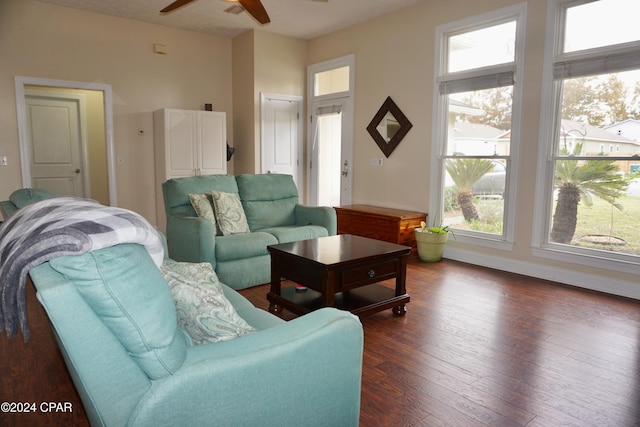 living room with dark hardwood / wood-style floors and ceiling fan