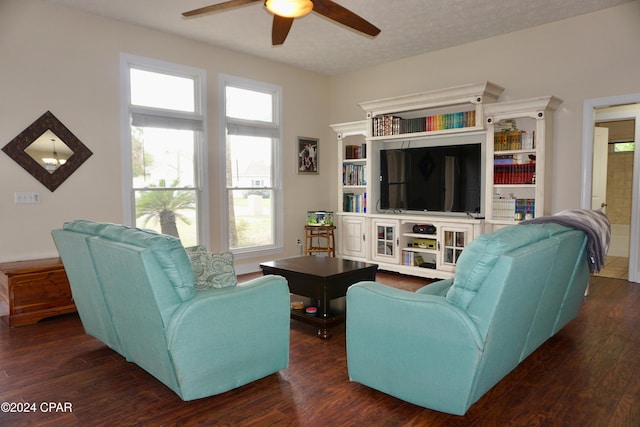 living room with a textured ceiling, dark hardwood / wood-style floors, and ceiling fan