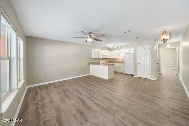 unfurnished living room with hardwood / wood-style floors and ceiling fan