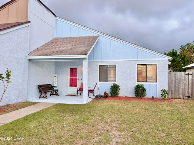 view of front facade with a patio and a front lawn