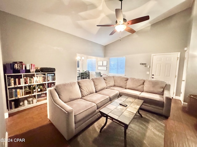 living room featuring ceiling fan with notable chandelier, wood-type flooring, and high vaulted ceiling