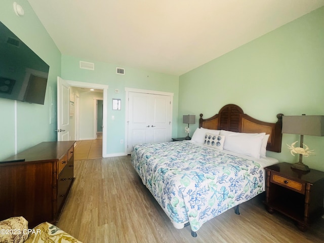 bedroom featuring a closet and light hardwood / wood-style floors