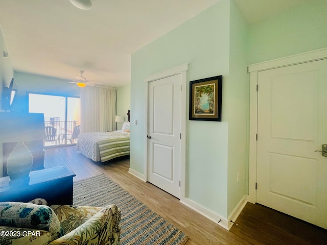 bedroom featuring hardwood / wood-style flooring, access to outside, and ceiling fan