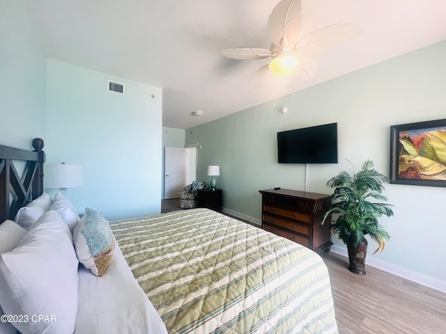 bedroom with light hardwood / wood-style floors and ceiling fan