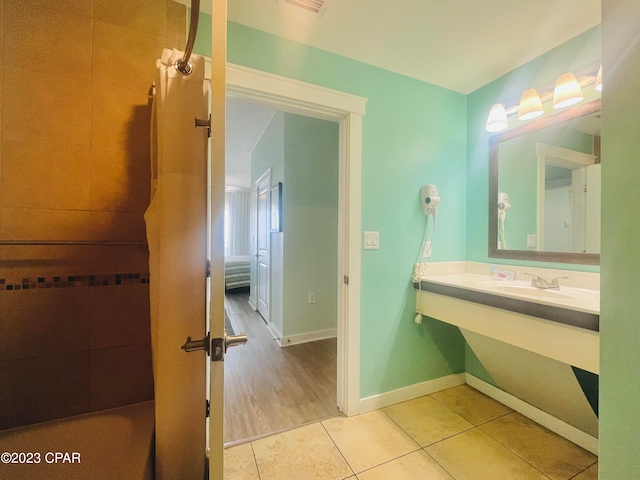 bathroom featuring wood-type flooring and sink