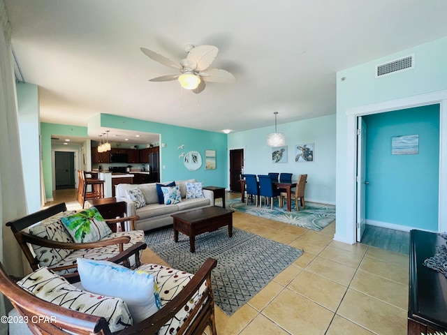 living room with ceiling fan and light tile patterned floors