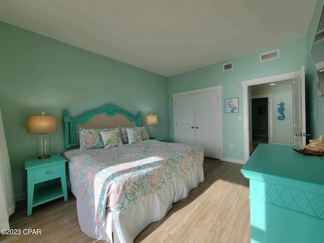 bedroom with hardwood / wood-style flooring and a closet