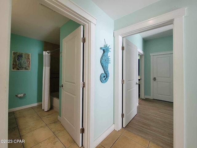 corridor with light tile patterned floors