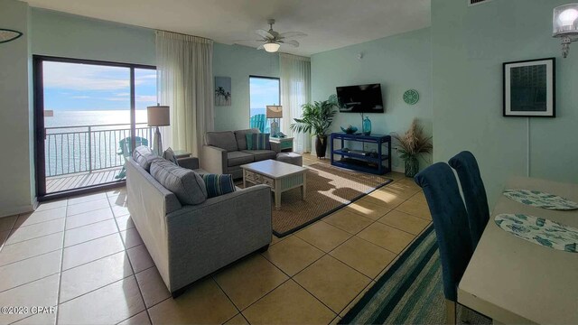 15100 Front Beach Rd Unit 1604, Panama City Beach, FL 32413 - living area with light tile patterned floors, ceiling fan, and a water view