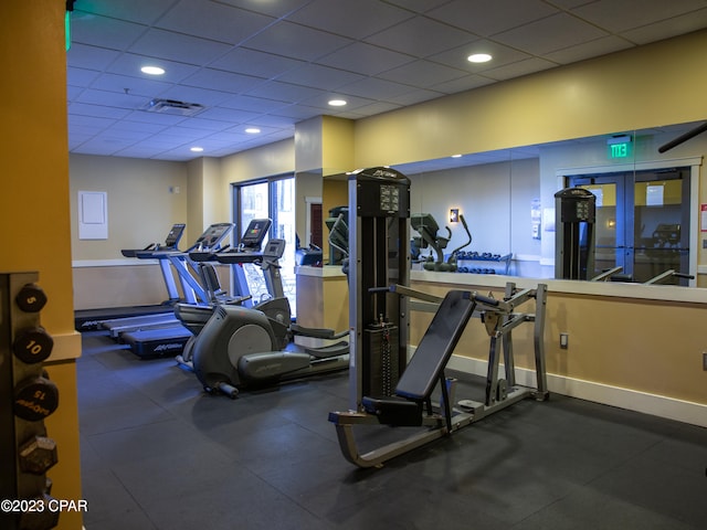 gym with a paneled ceiling