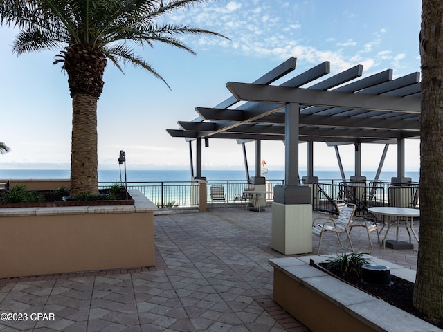 view of patio featuring a water view and a pergola