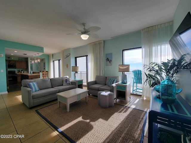 tiled living room with ceiling fan and a healthy amount of sunlight