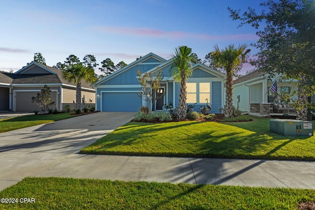 view of front of property with a garage and a lawn