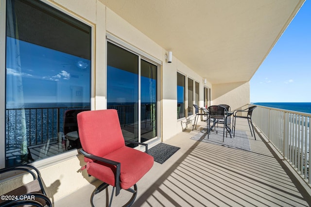 8715 Surf Dr Unit 1402B, Panama City, FL 32408 - balcony with a water view and outdoor dining area