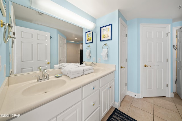 bathroom featuring vanity, walk in shower, and tile patterned floors