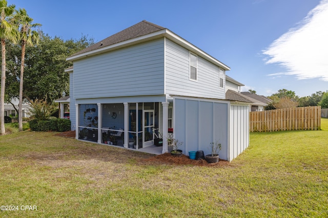 rear view of property with a lawn