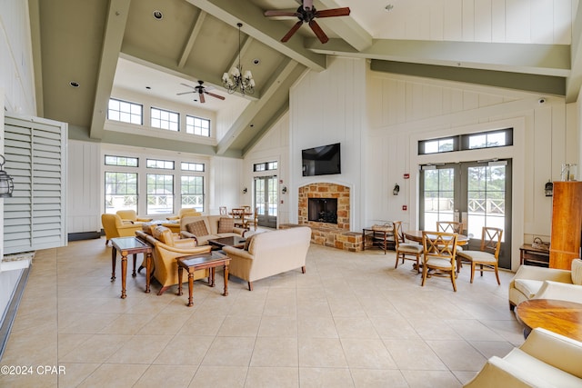 living room with high vaulted ceiling, ceiling fan, a healthy amount of sunlight, and a stone fireplace