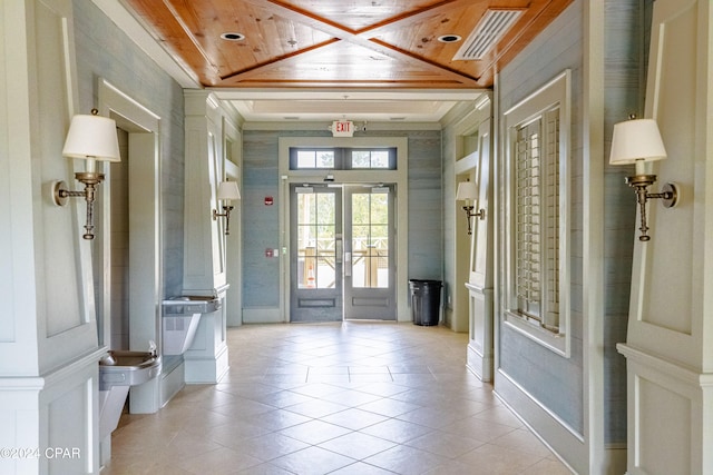 tiled foyer featuring wooden ceiling and french doors