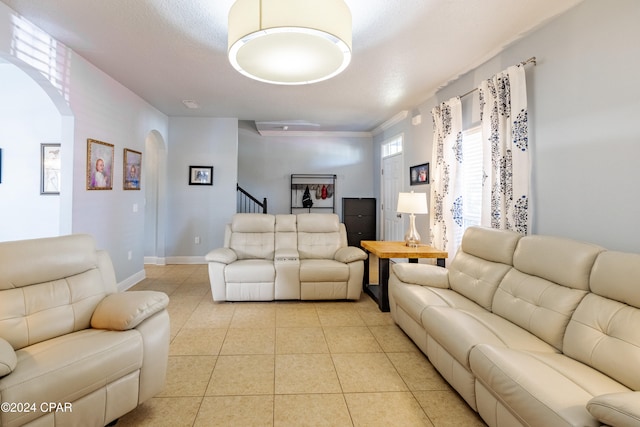 living room with light tile patterned flooring and a textured ceiling