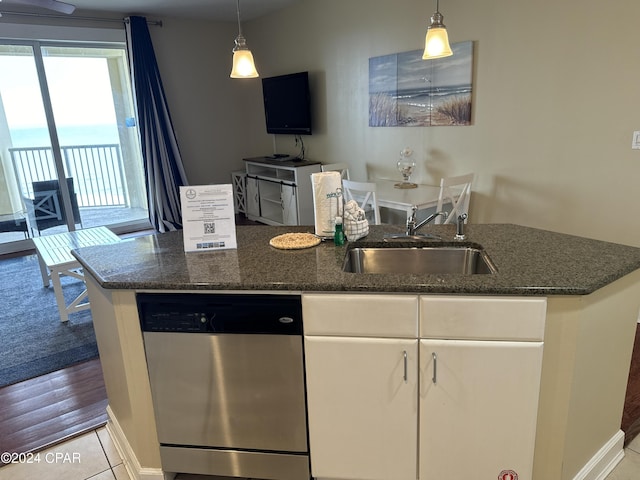 kitchen featuring white cabinets, pendant lighting, stainless steel dishwasher, and sink