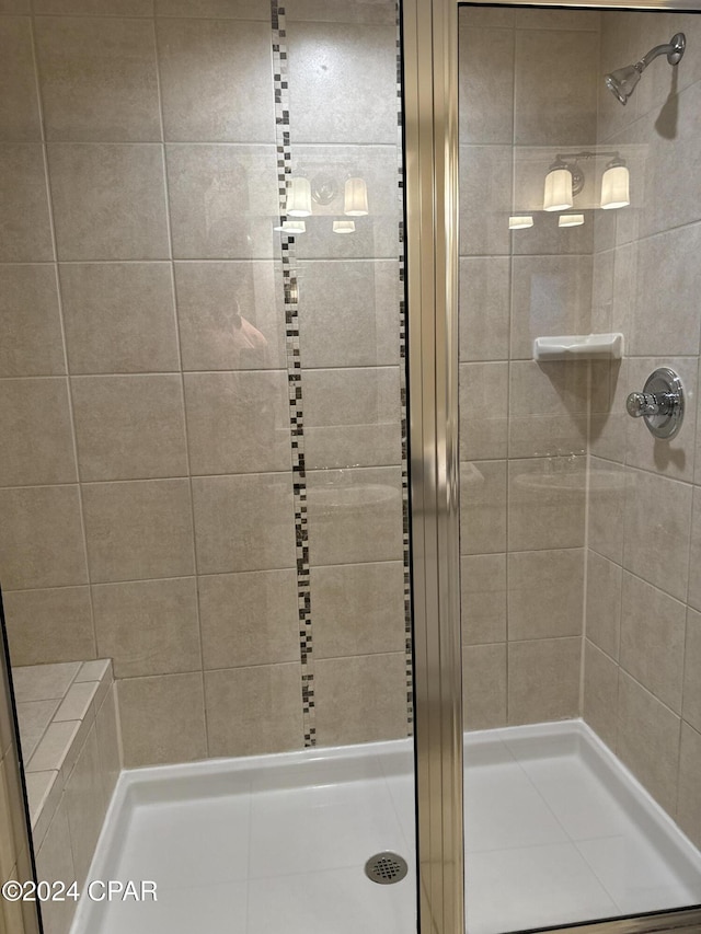 bathroom with a shower with shower door