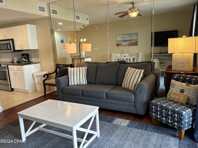 living room featuring hardwood / wood-style flooring and ceiling fan