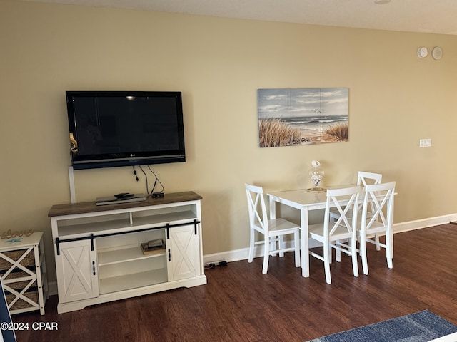 dining area with dark hardwood / wood-style flooring and lofted ceiling