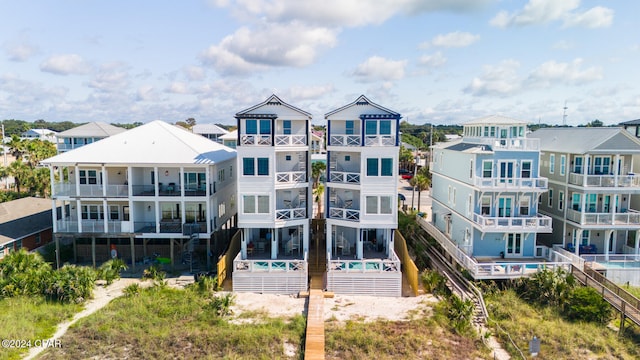 back of house featuring a balcony and a patio area