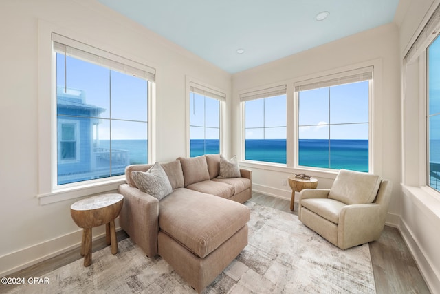 sunroom with plenty of natural light and a water view