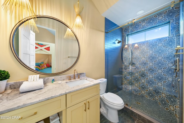 bathroom with toilet, vanity, tile patterned flooring, and a shower with door