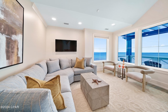 carpeted living room with ornamental molding and lofted ceiling