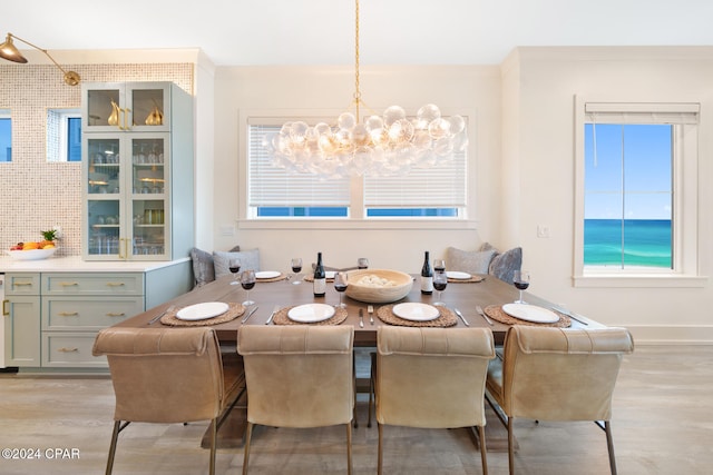 dining room with a chandelier and light hardwood / wood-style floors